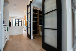 a room with double barn doors with diffused white laminate inserts 