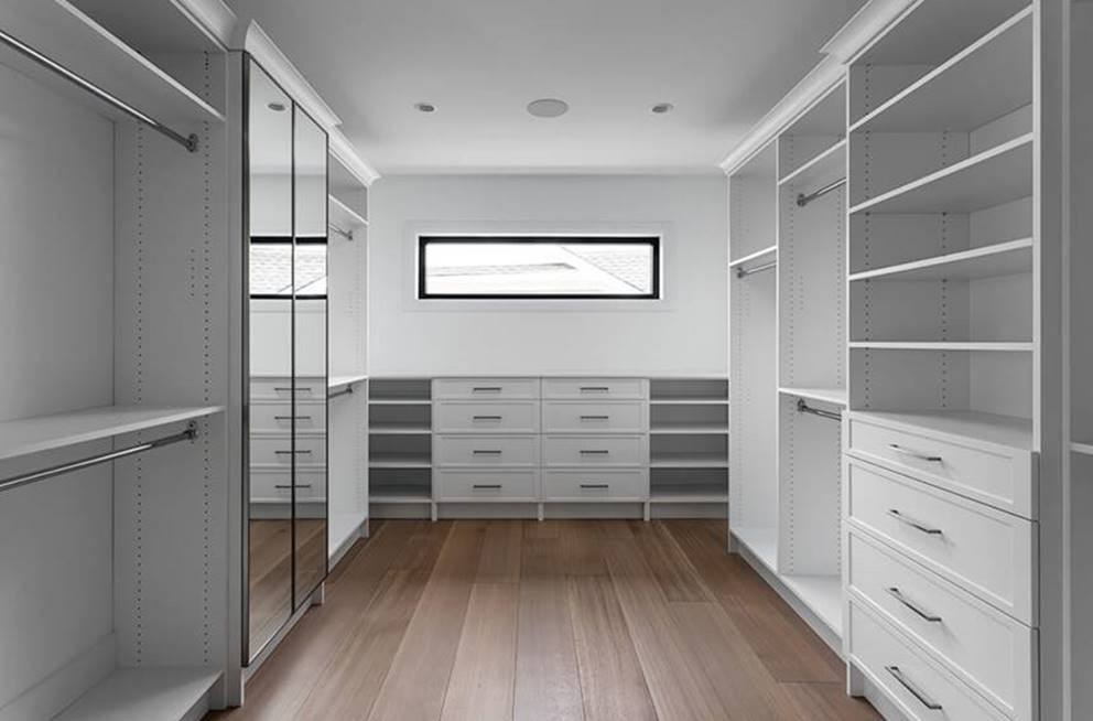 custom walk in closet with mirrored doors