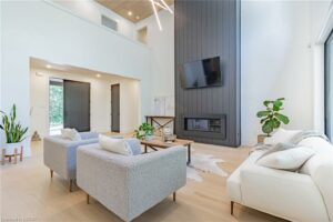 home with modern esthetic living room featuring black doors and shiplap fireplace
